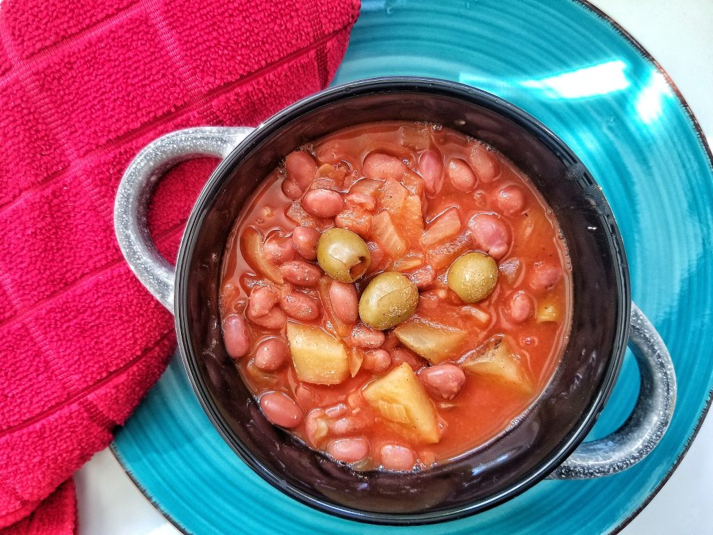 A large bowl of savory Puerto Rican pink bean stew, or habicuelas guisadas
