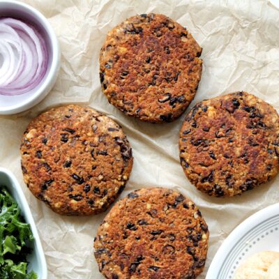 Vegan burger made with tofu, black beans, and mushrooms with toppings