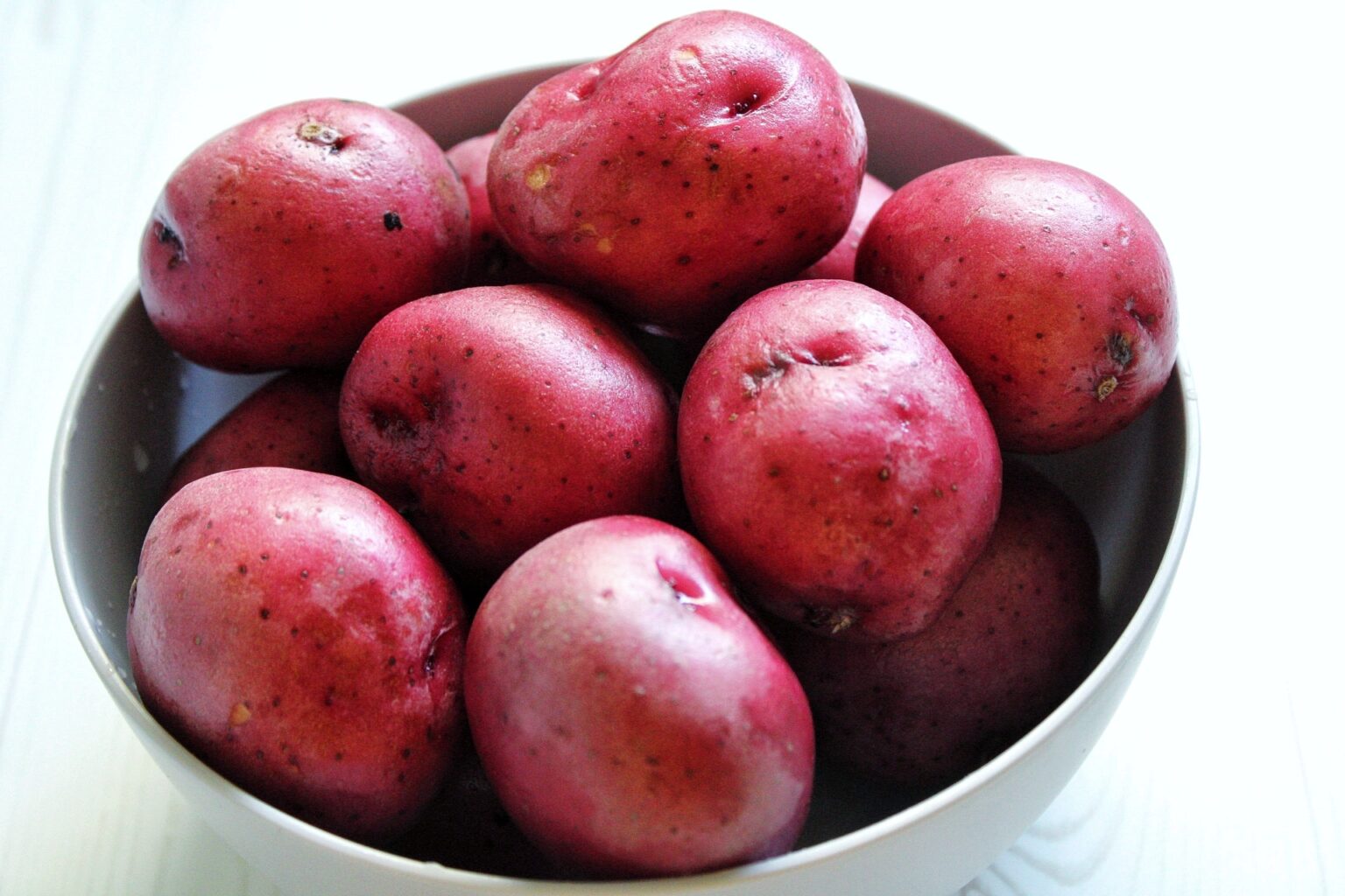 Bowl of whole, red potatoes. 