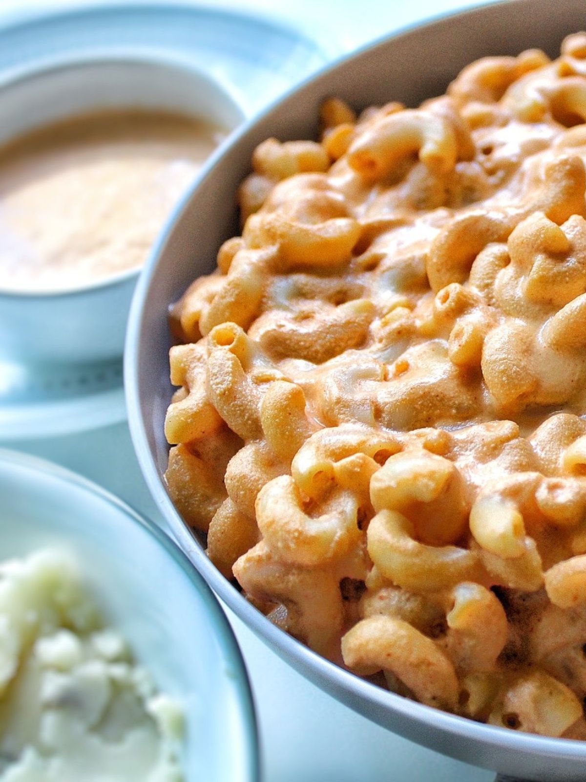 Bowl of vegan Mac and cheese with sides.