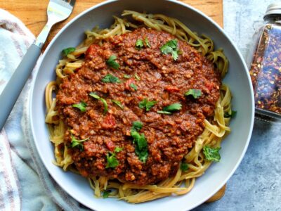 Pasta with vegetarian bolognese sauce topped with cilantro.