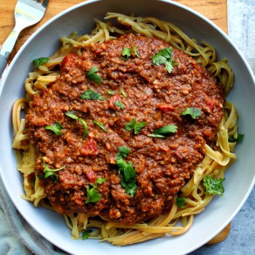 Pasta with vegetarian bolognese sauce topped with cilantro.