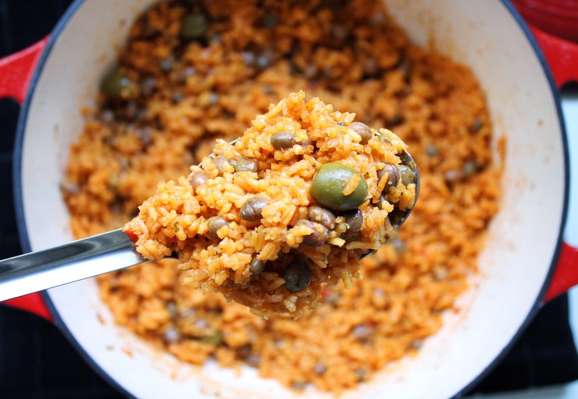 Closeup Puerto Rican rice scooped in serving spoon