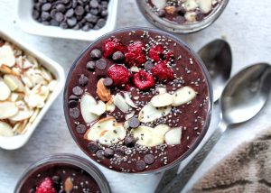 Chocolate chia seed pudding with slices almonds, chocolate chips, and raspberries