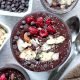 Chocolate chia seed pudding with slices almonds, chocolate chips, and raspberries