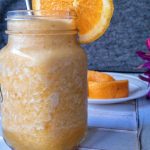 Cold pineapple smoothie with a slice of orange