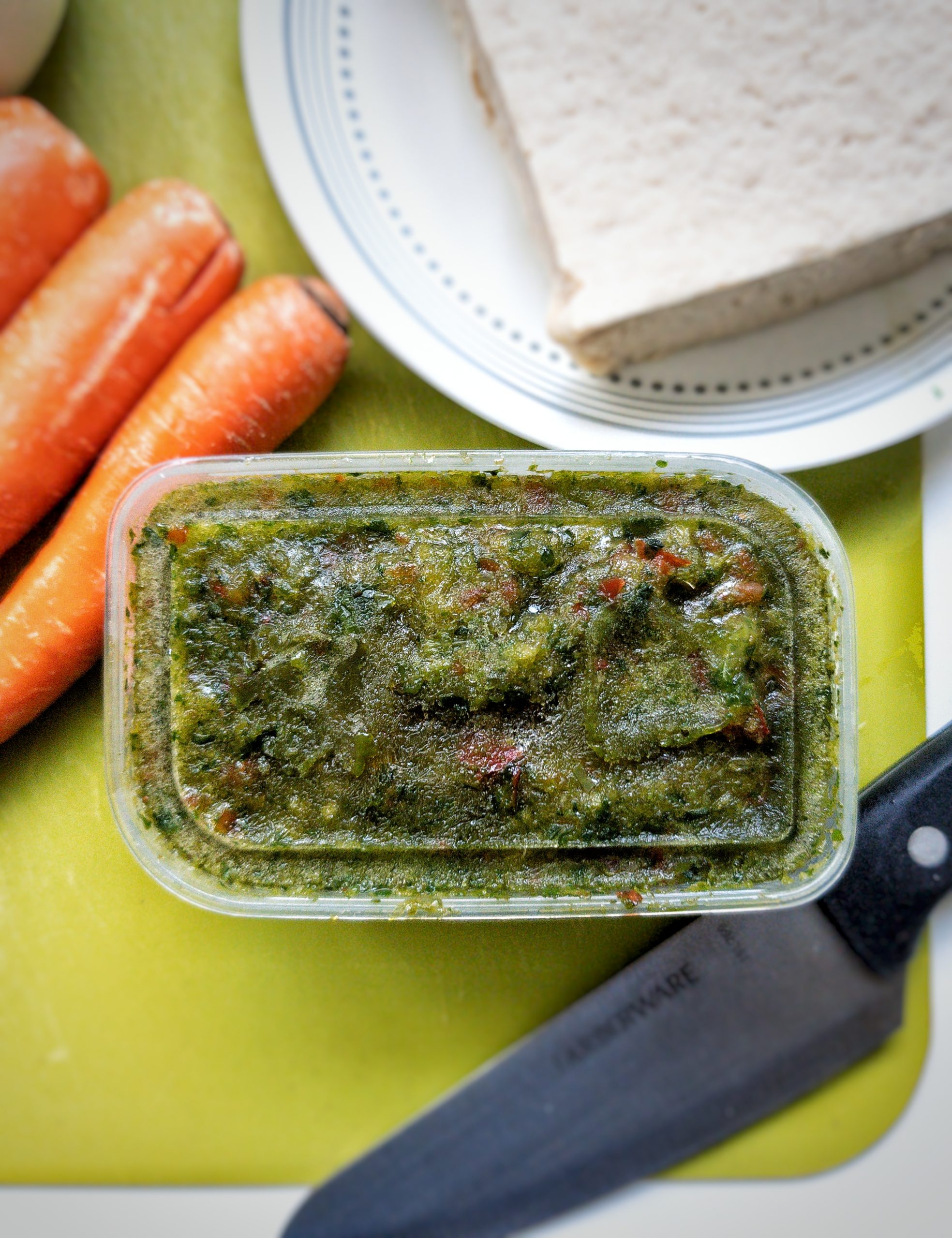 Homemade sofrito in a container. Close-up.