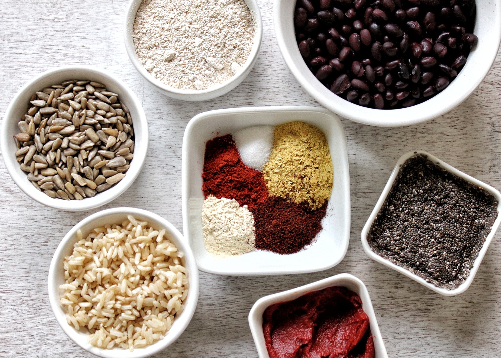 Black beans, oat flour, sunflower seeds, brown rice, tomato paste, chia seeds, and spices