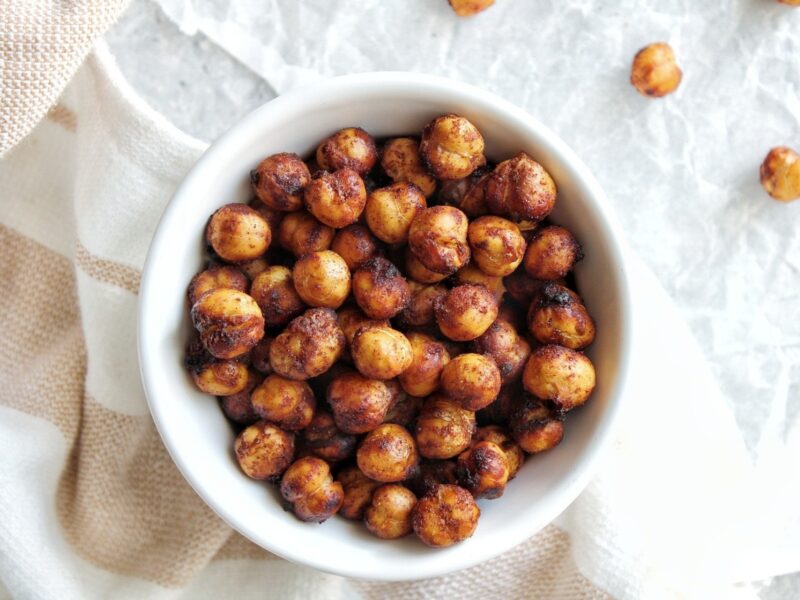 Air fryer chickpeas with cinnamon and brown sugar in a small, white serving bowl.