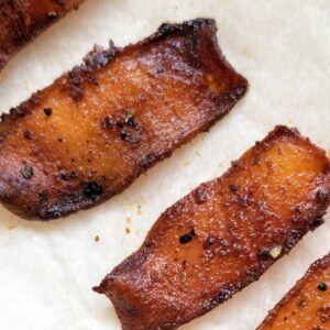 Strips of veggie bacon against parchment paper