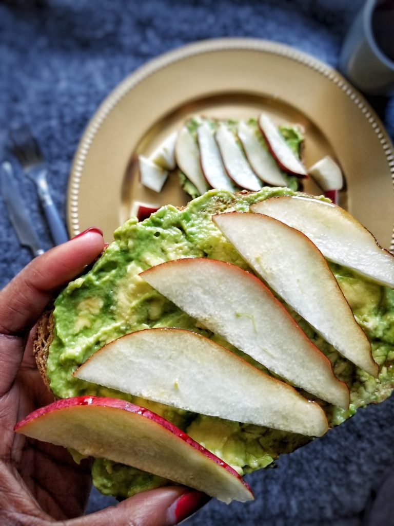 Toasted bread topped with avocado and sliced pears