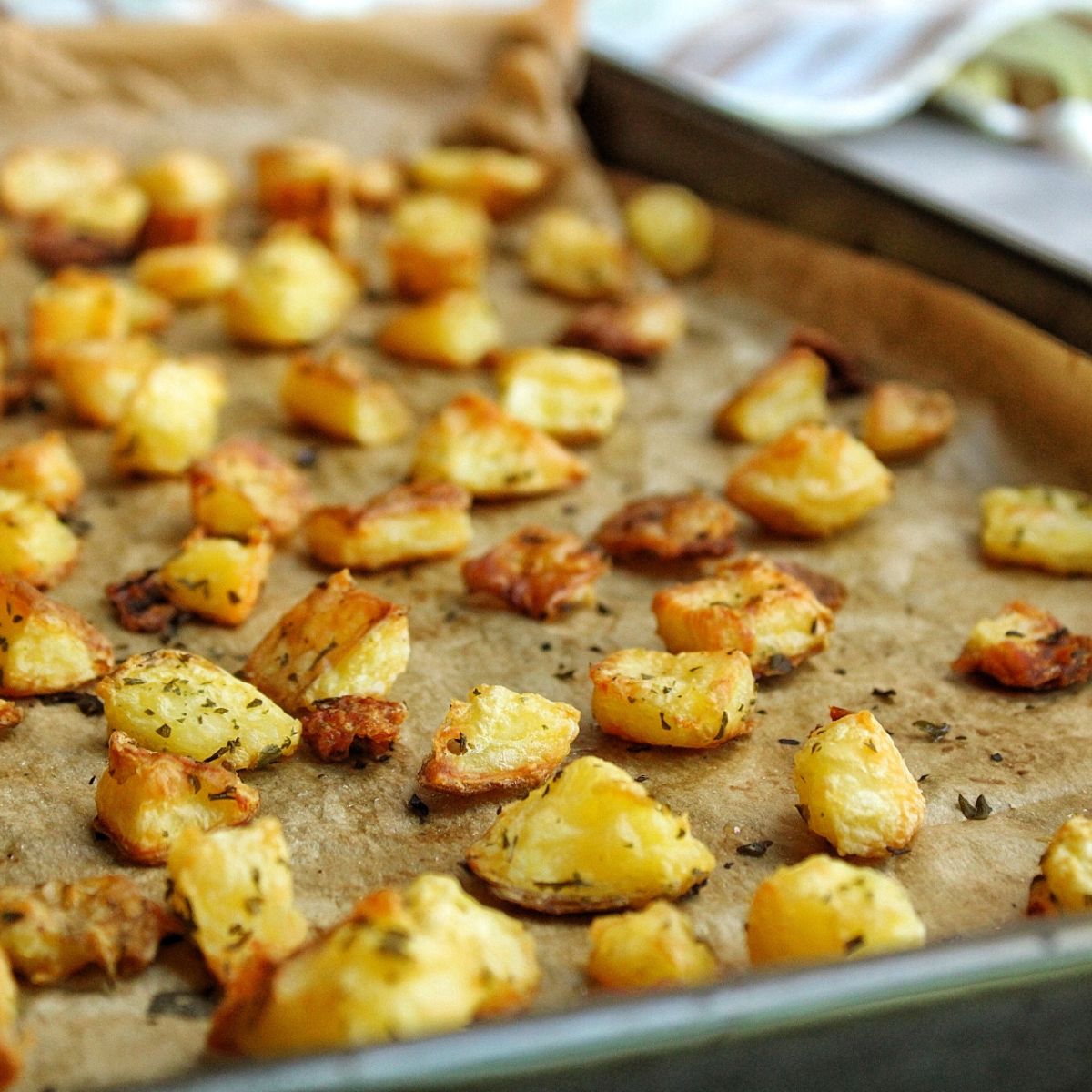 Closeup of the fiinish result. Roasted potatoes on a baking sheet with parchment paper.