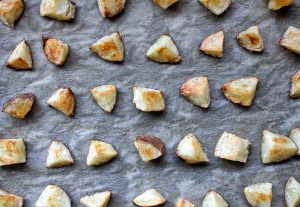 Chopped russet potatoes baked on parchment paper