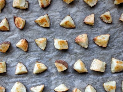 Chopped russet potatoes baked on parchment paper