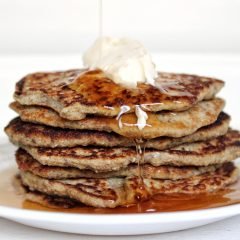Stack of gluten-free banana vegan pancakes with vegan butter and syrup