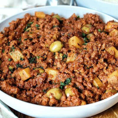 Vegan picadillo with Spanish green olives and potatoes in a serving bowl.