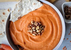 Soup made with lentils, carrots, and ginger served with a homemade flatbread