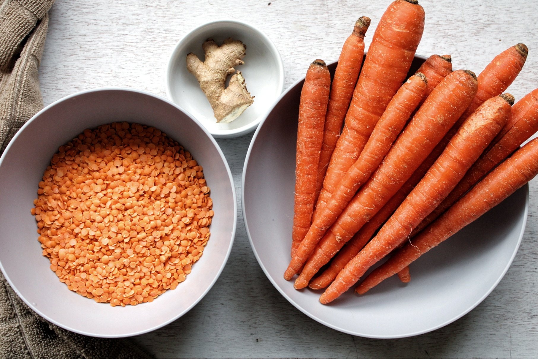 Ingredients for soup: red split lentils, ginger, and carrots 