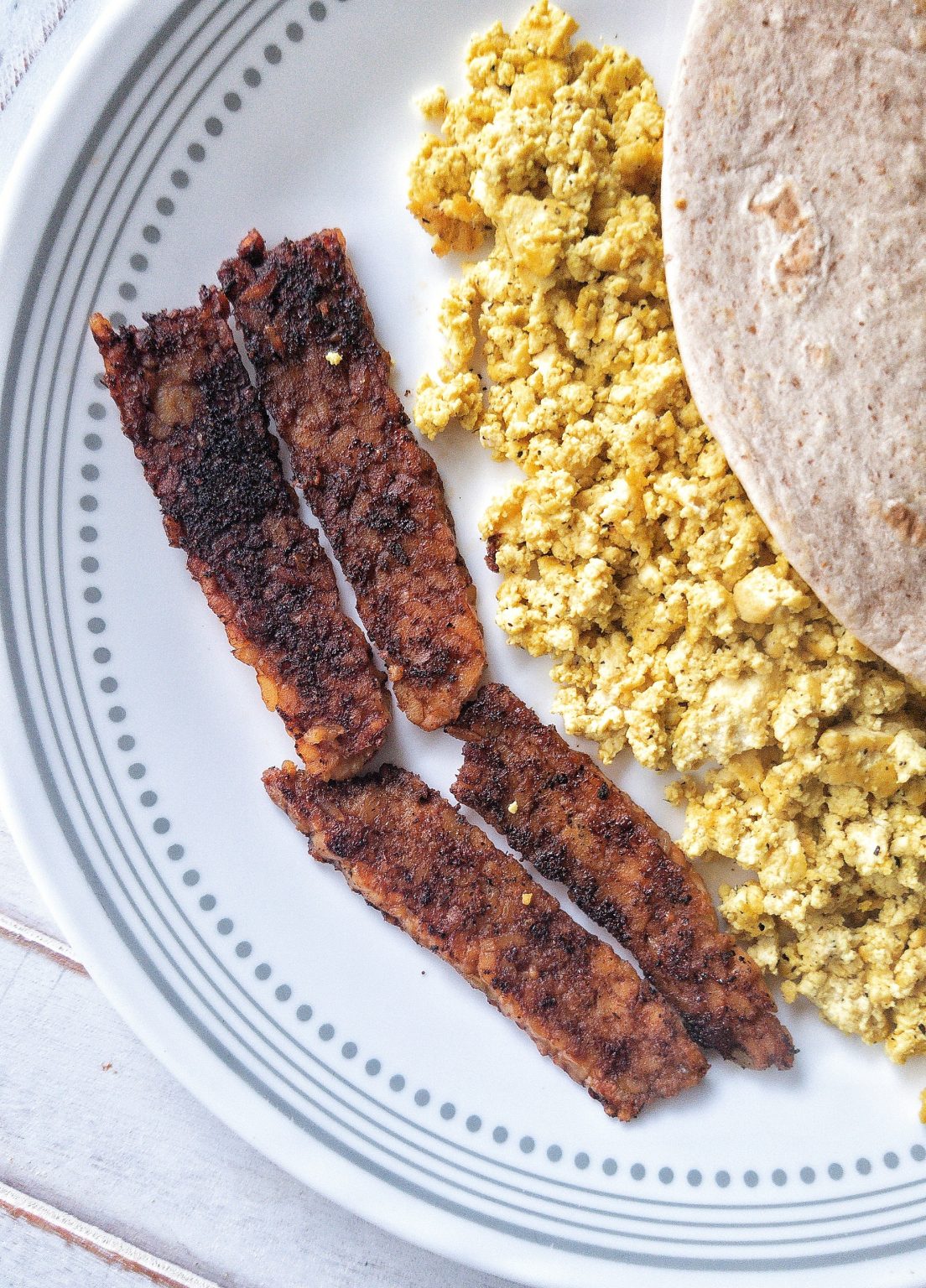 Smoky tempeh bacon with a side of tofu scramble and tortilla