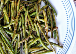 Pan-fried blistered green beans on a plate