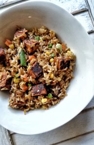 Bowl of stir-fried rice with tofu and mixed vegetables