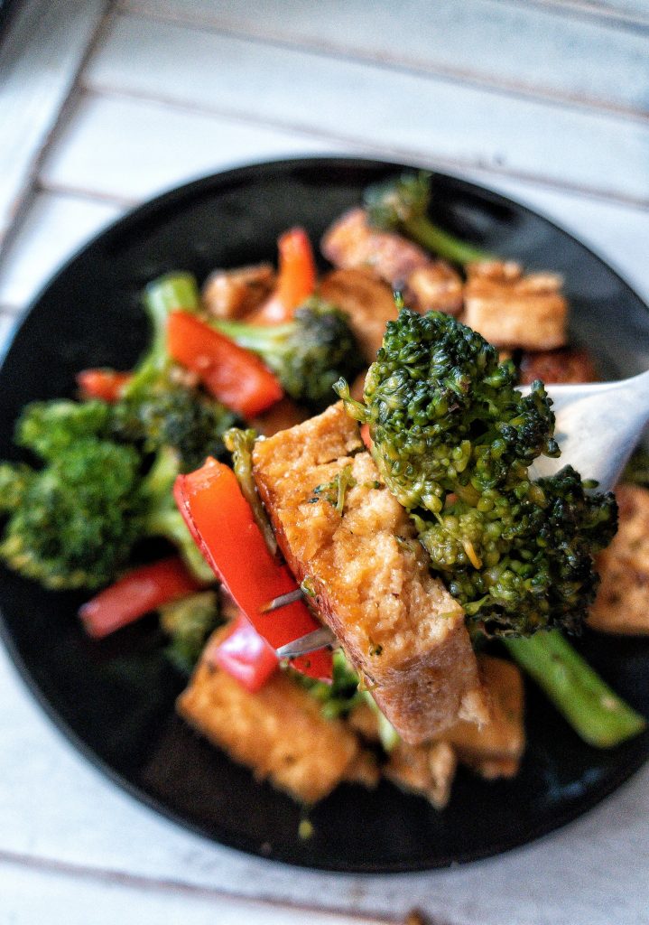 Close up of broccoli, tofu, and red bell pepper