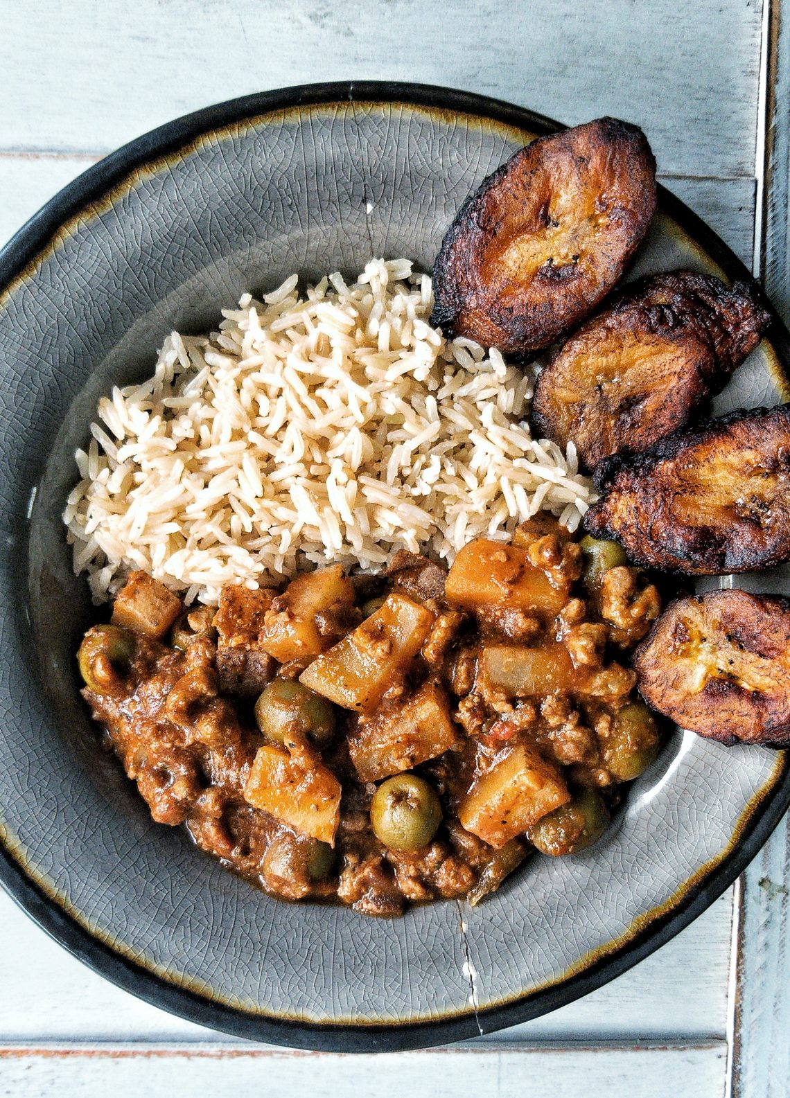 Puerto-Rican style picadillo stewed with potatoes and Spanish olives. With a side of sweet plantains and rice.