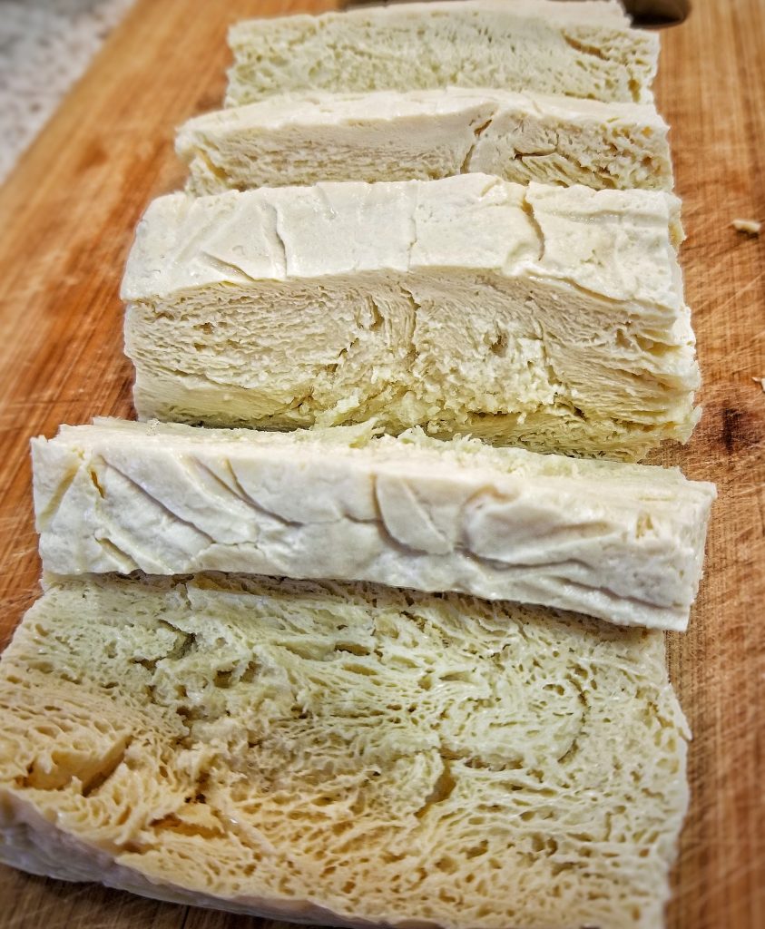 Up close image of how porous or sponge-like tofu becomes after being frozen and then thawed 