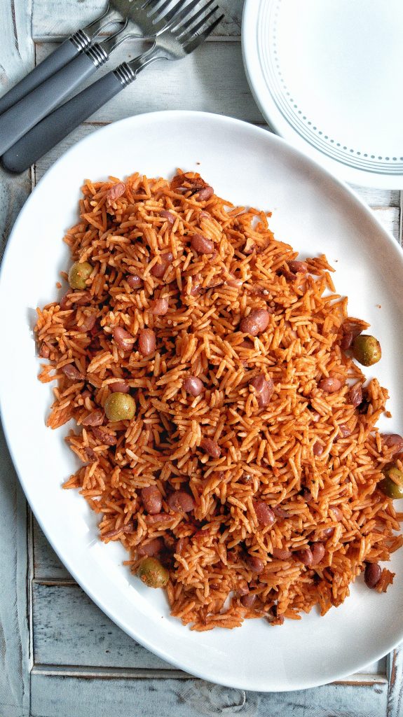 Seasoned Puerto Rican yellow rice with red beans, Spanish olives, tomato sauce on a large plate