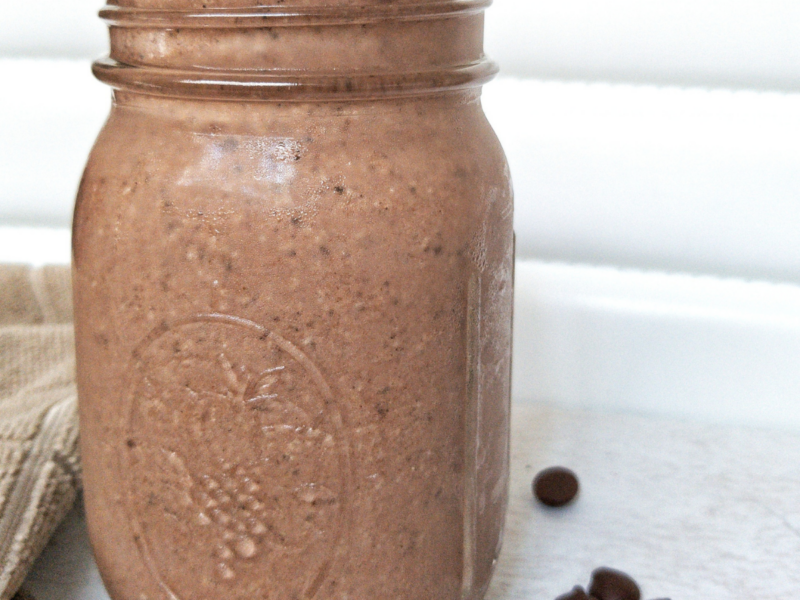 Protein chocolate peanut butter smoothie in a mason jar with a metal straw