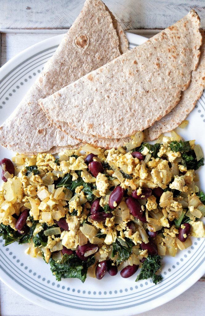 Less or fewer than 10 ingredients loaded tofu scramble with kale, beans veggies, and warm tortillas