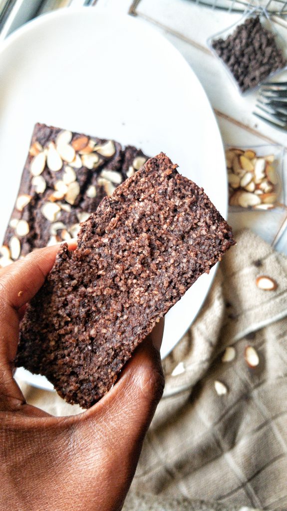A slice of plant-based, Gluten-Free Double Chocolate Banana Bread topped with almonds.