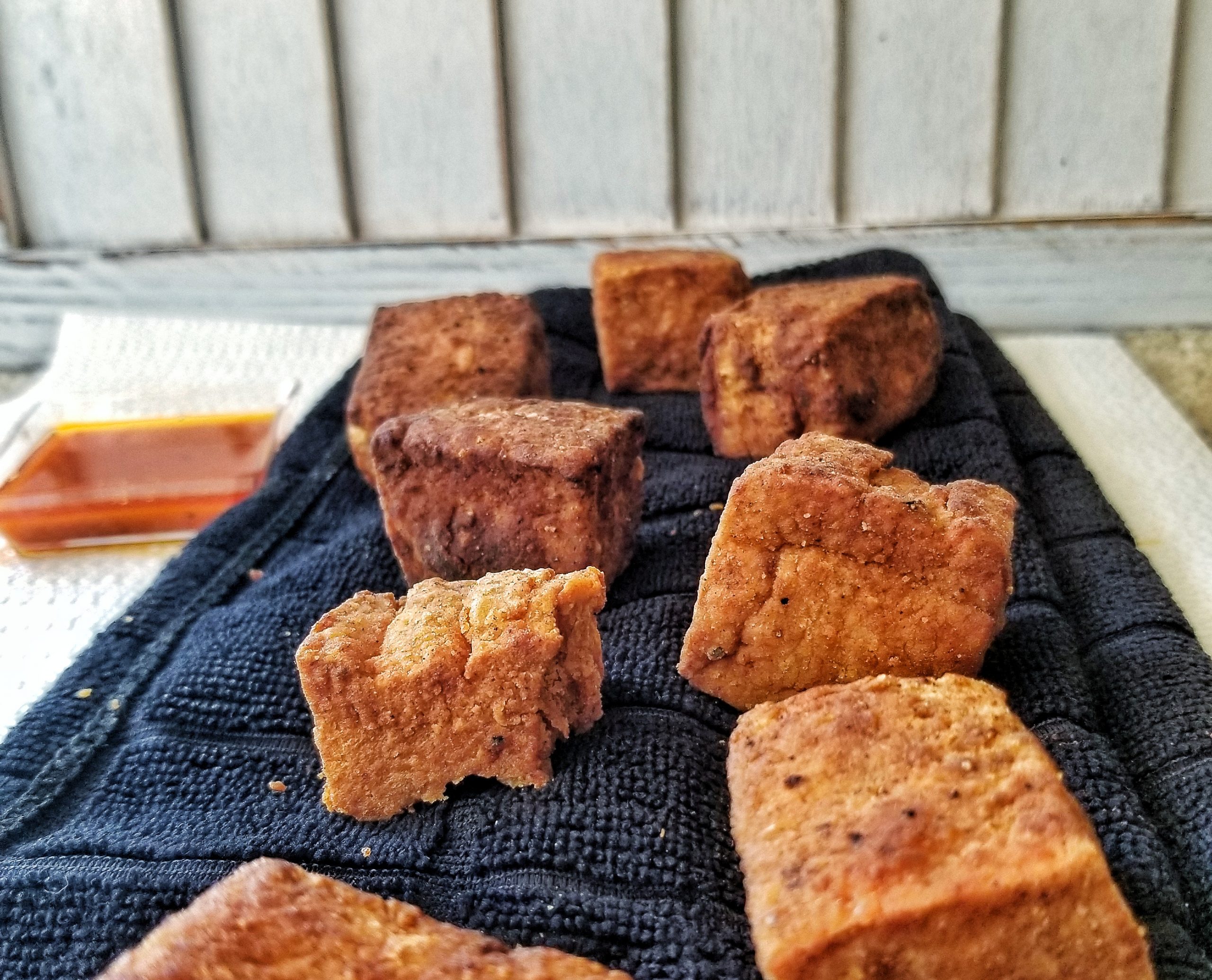 Crispy, golden tofu cubes or nuggets that have been cooked pan-fried from frozen. 