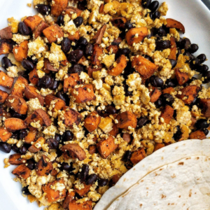 Sweet potato tofu scramble with beans and tortilla on the side.