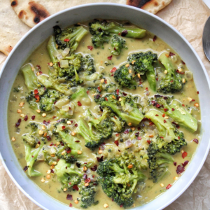 Bowl of vegetable broccoli curry with flatbread.