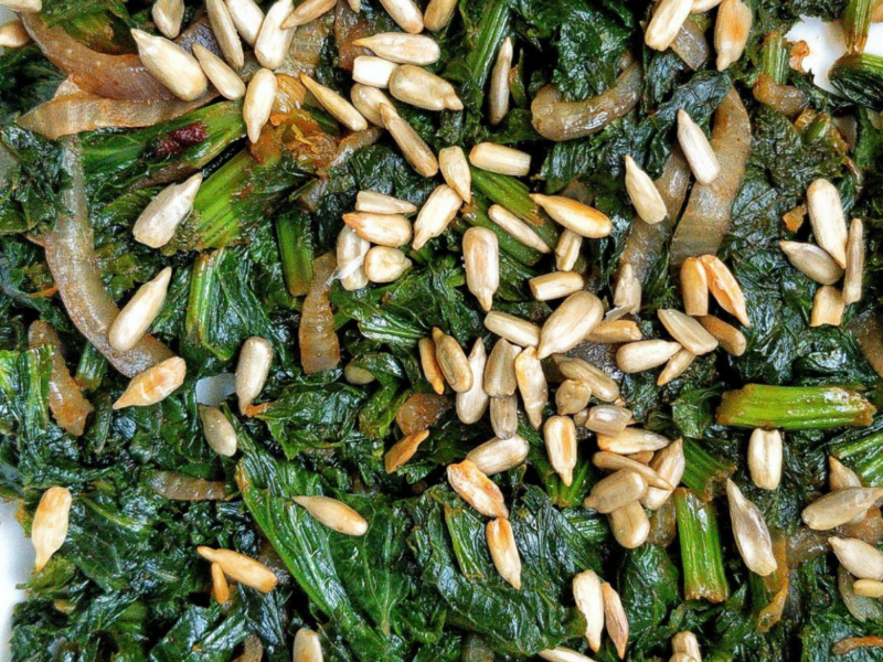 Pan-cooked curly mustard greens with lightly salted roasted sunflower seeds.