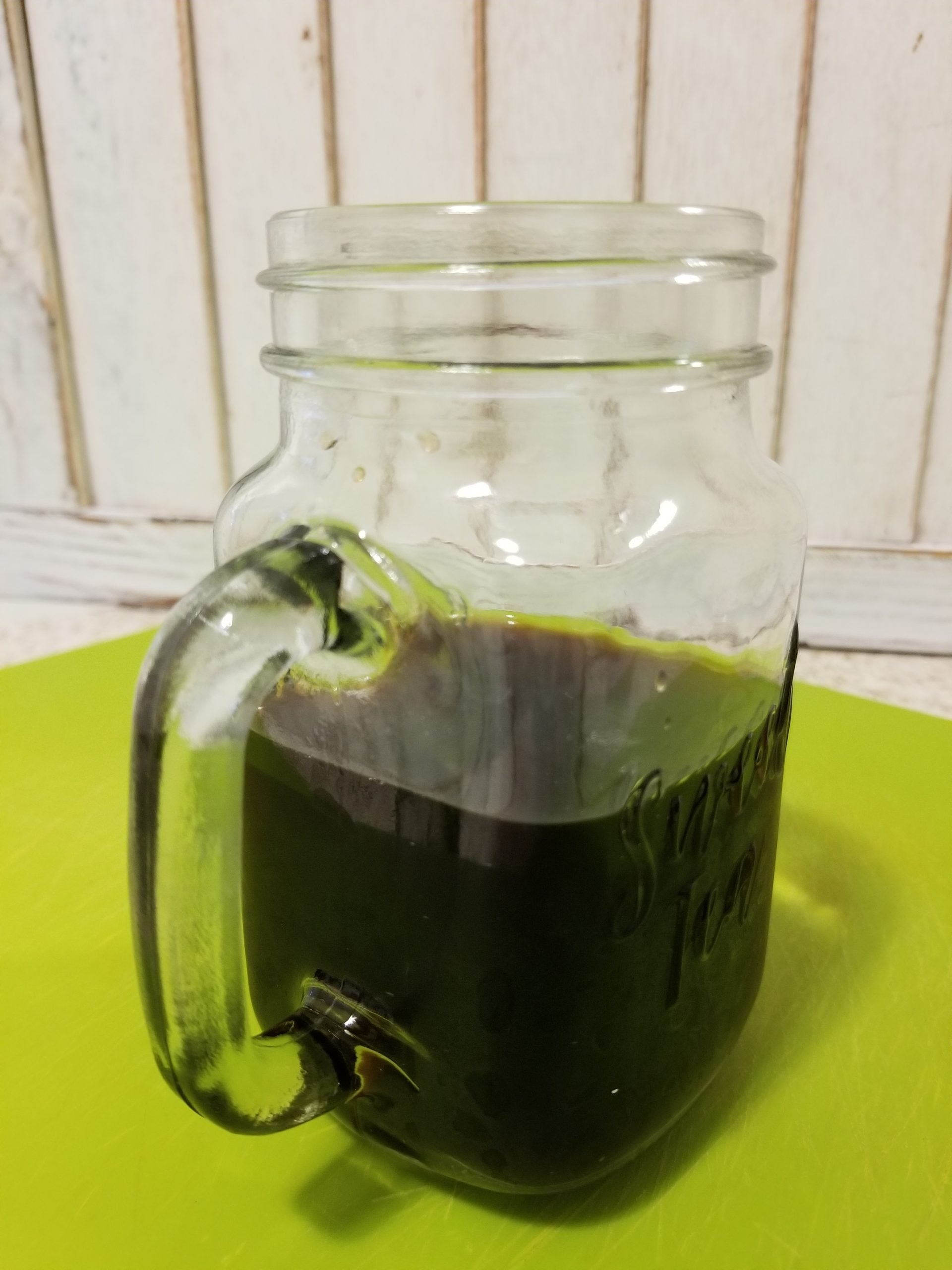 Cold coffee in a clear glass mug