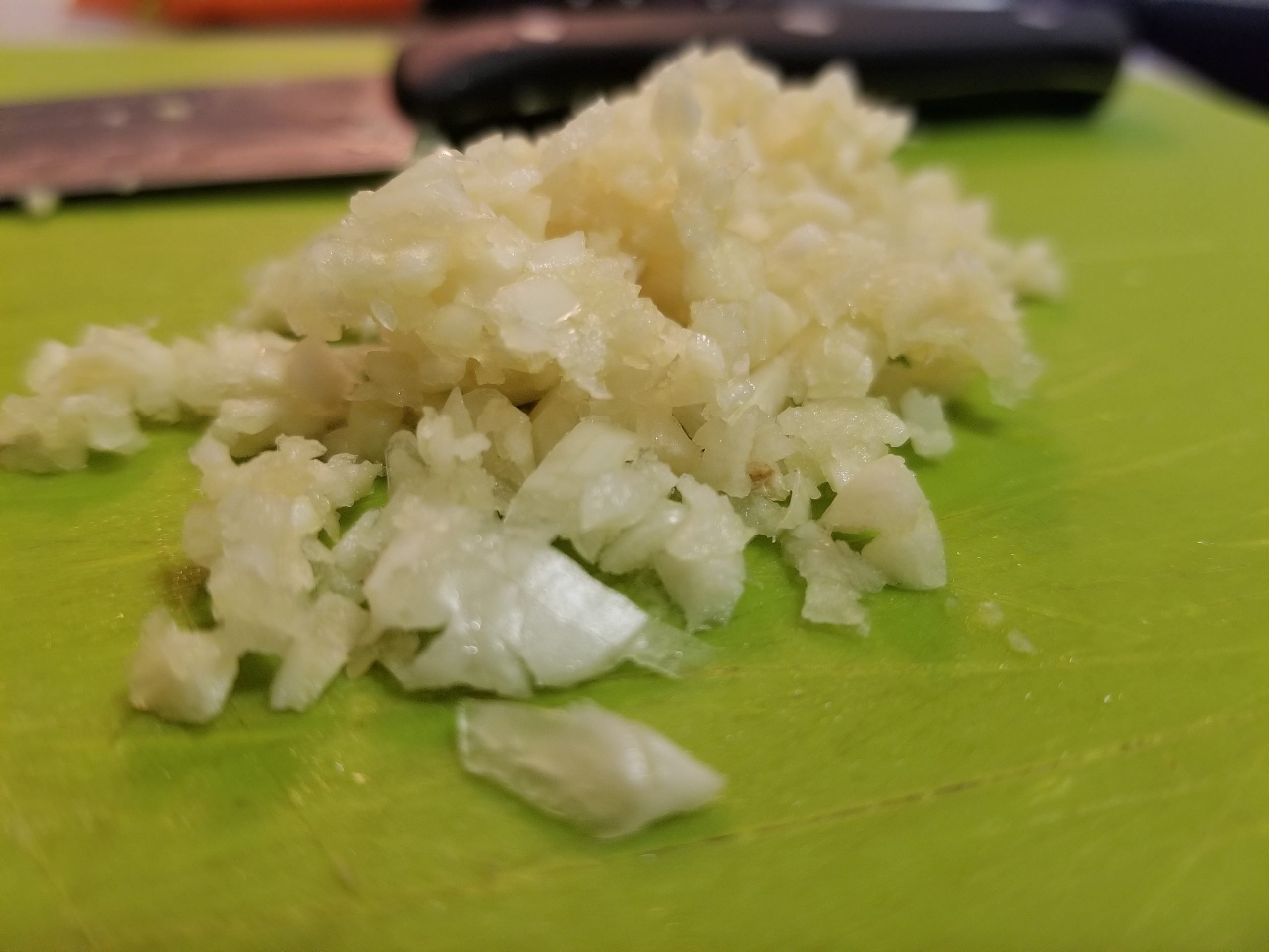 Minced garlic on a chopping board