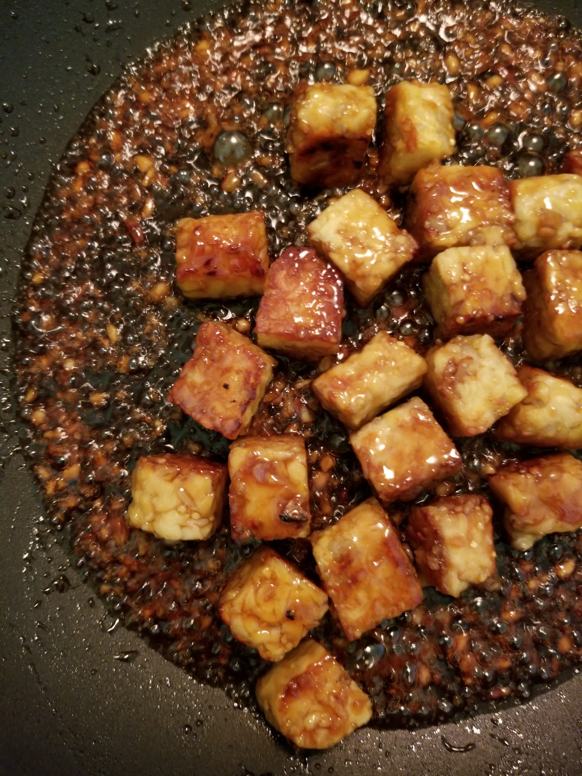 Chopped tempeh cubes stir-fried and cooked in a honey garlic sauce