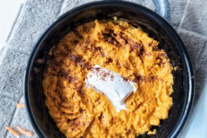 Vegan mashed carrots with cinnamon and brown sugar topped with vegan butter