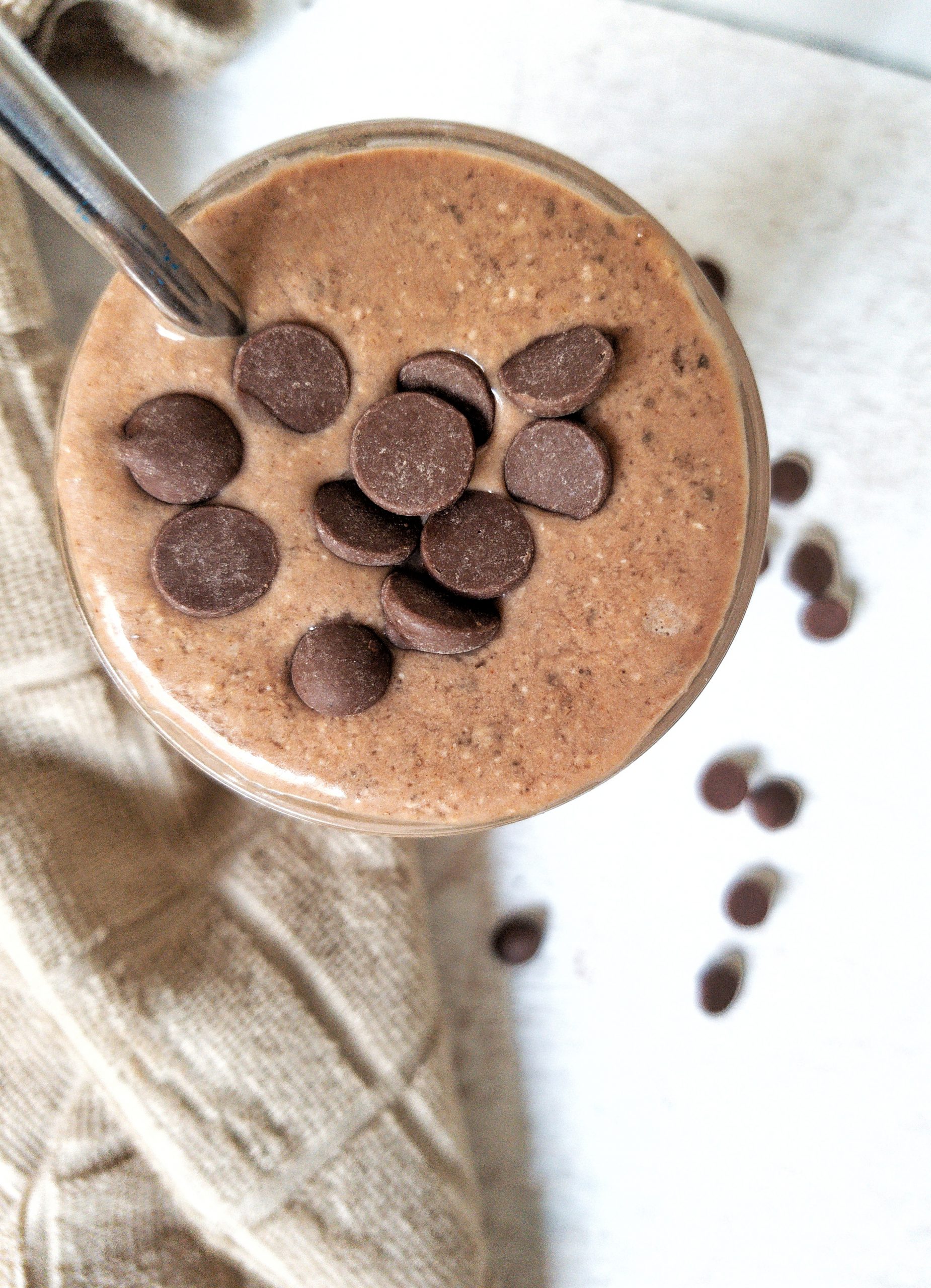 Peanut butter smoothie topped with chocolate chips.