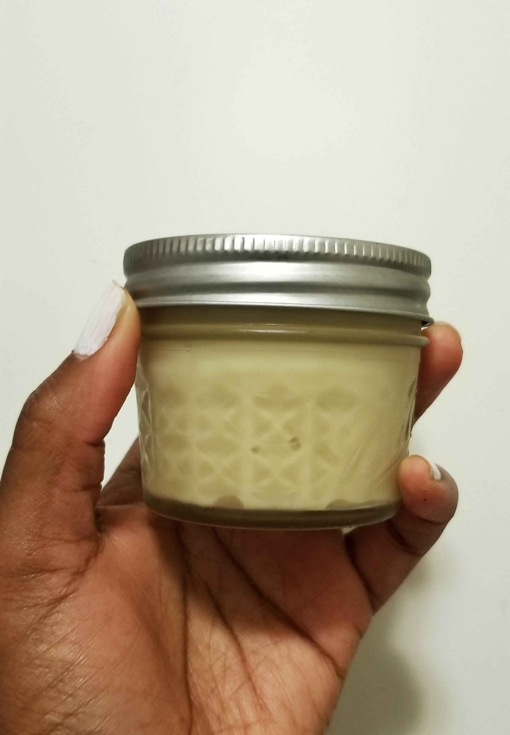 Dulce de leche in a small, 4-ounce canning jar. 