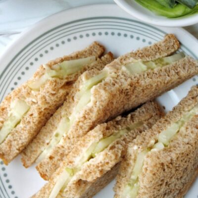 Cucumber tea sandwiches cut into 4 triangles.