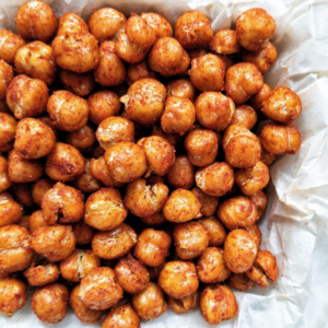 Crispy chickpeas seaoned with paprika on parchment paper