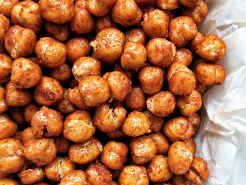 Crispy chickpeas seaoned with paprika on parchment paper
