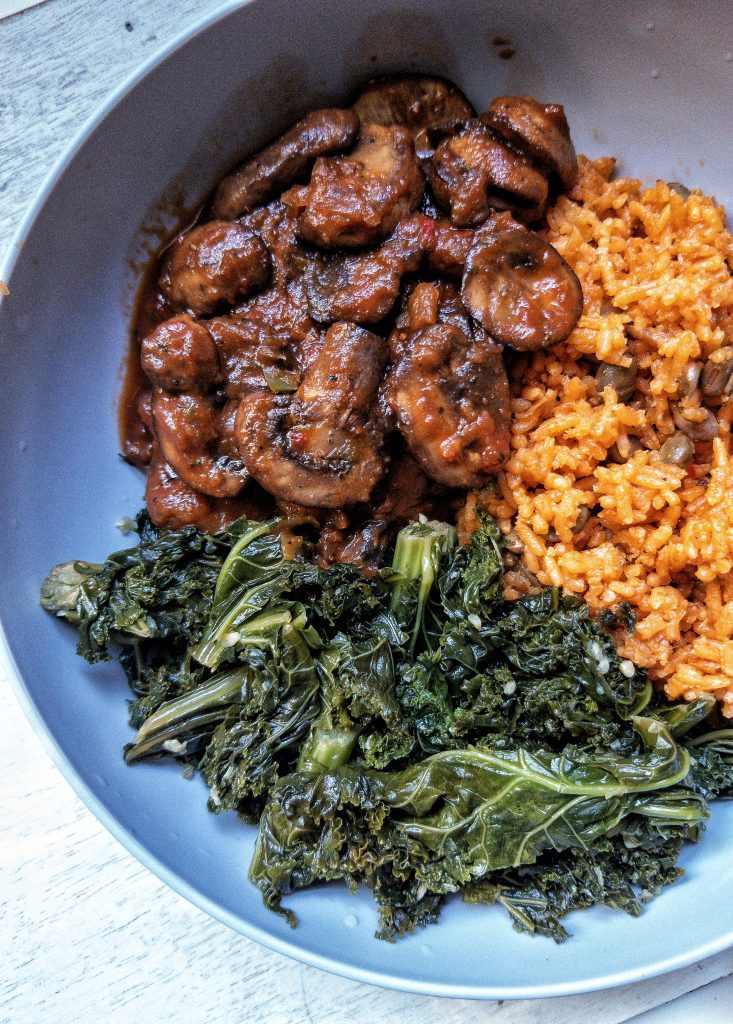 Garlic butter briased kale with a side of stewed mushrooms and yellow rice