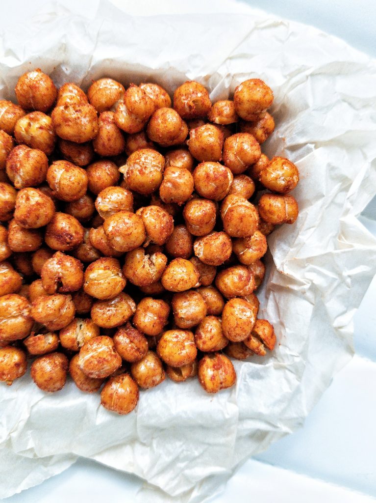 Roasted chickpeas with smoked paprika on top of parchment paper