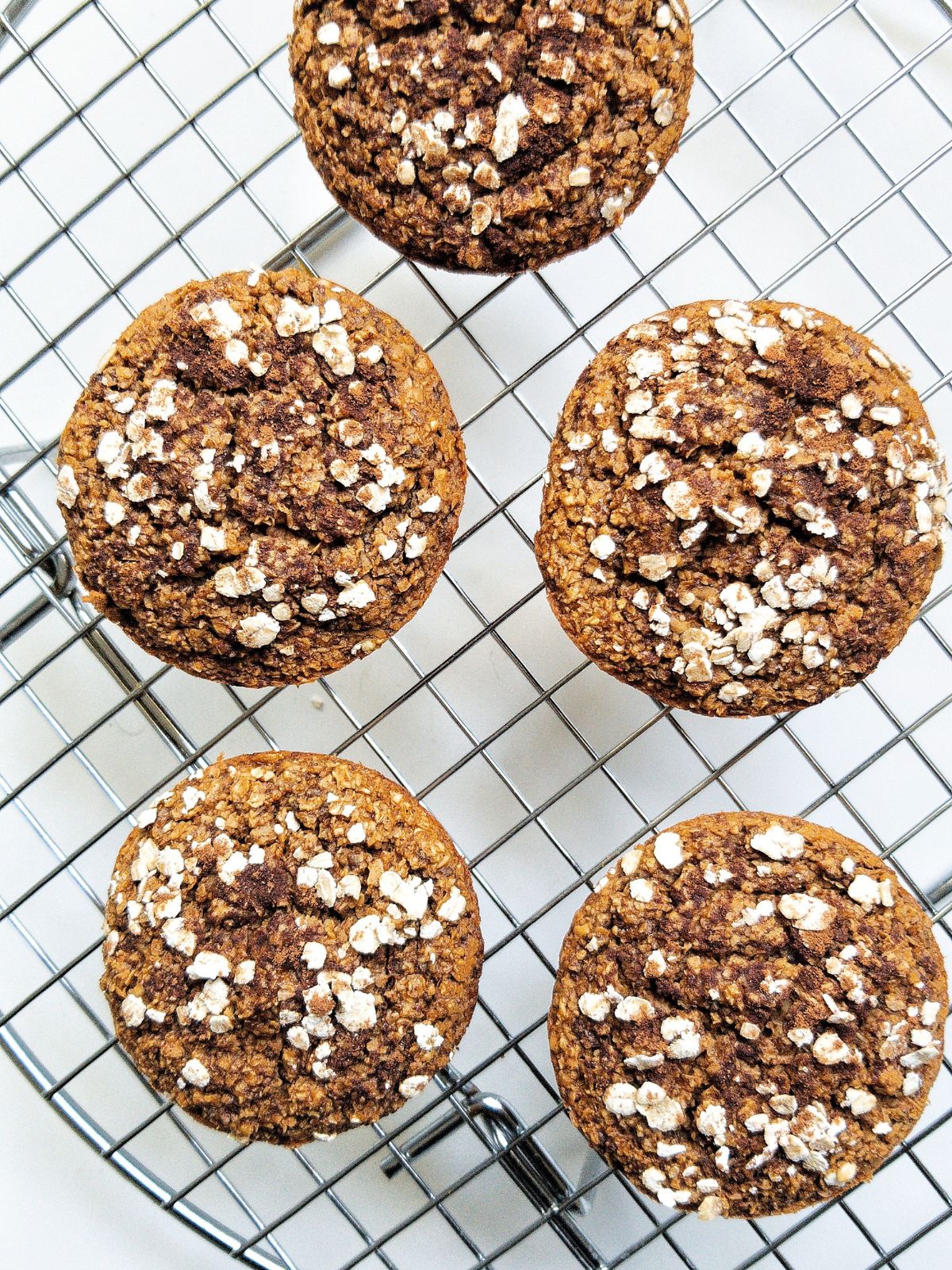 Above angle, Vegan Pumpkin Muffins on a cooling rack. 