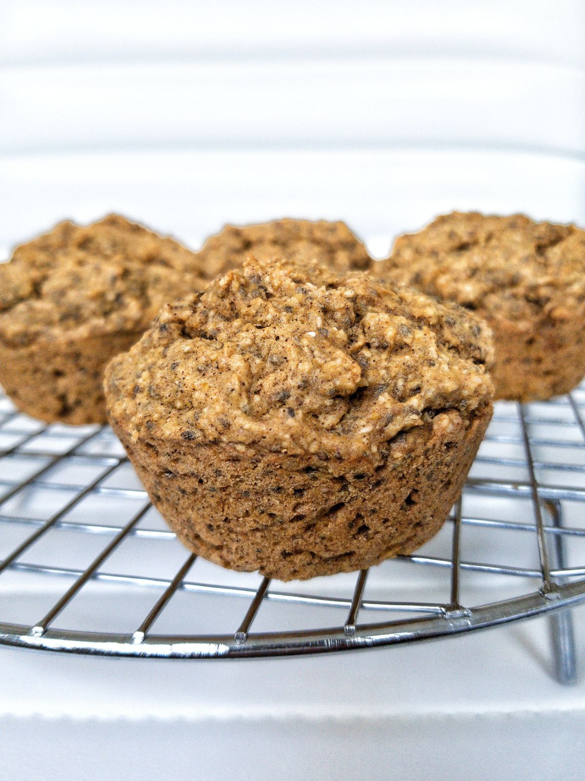 Vegan Pumpkin Muffins on a metal cooling rack. 