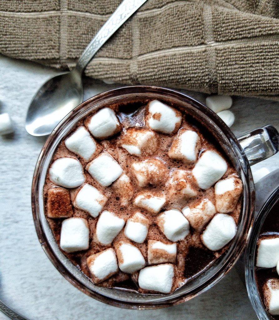Close-up of one glass mug with hot chocolate topped with marshmallows